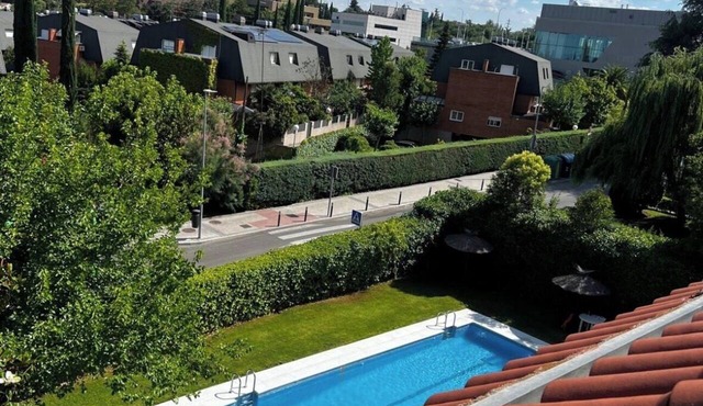 60-square-meter loft-style apartment with a separate kitchen and bathroom, swimming pool, parking, and garden.